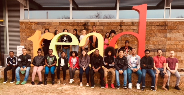 Students in front of giant letters spelling "read"